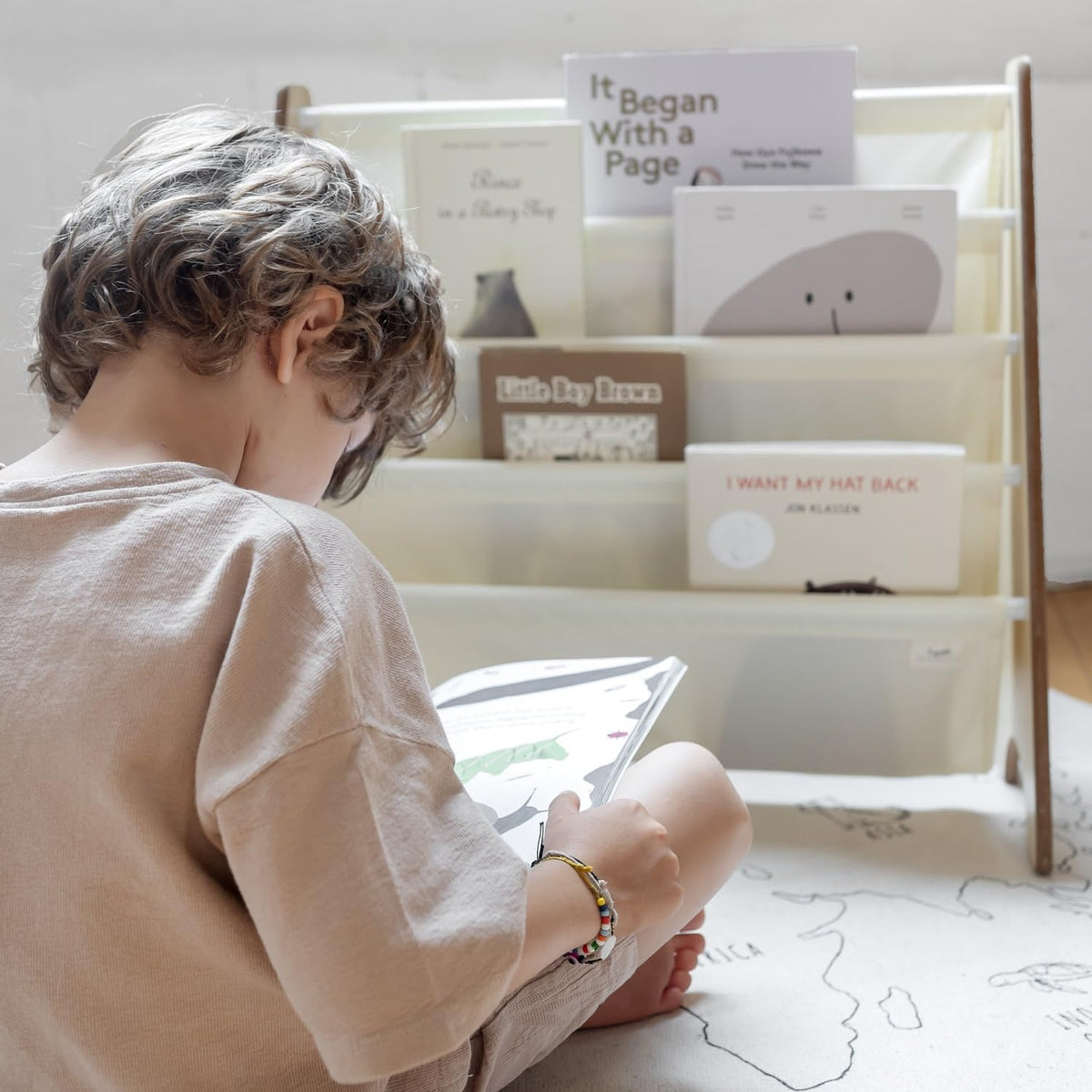 3 Sprouts cream-tone bookshelf complements modern nurseries while keeping books accessible
