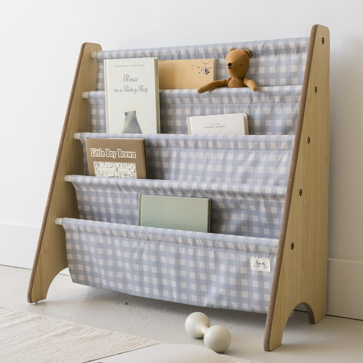 3 Sprouts bookshelf front view with sling storage for easy book access.