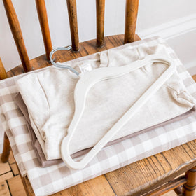 Durable plastic core of 3 Sprouts Velvet Hangers ensures daily nursery use.