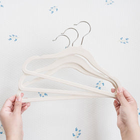 Thoughtful baby shower gift: 3 Sprouts Velvet Hangers set in cream.