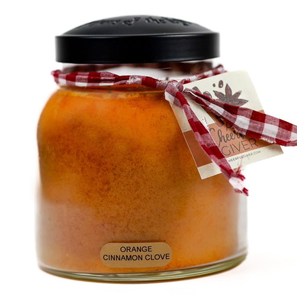 A Cheerful Giver orange cinnamon clove candle jar for a warm, inviting scent.
