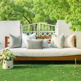 a moment green cushion cover on garden seating, outdoor-ready setup