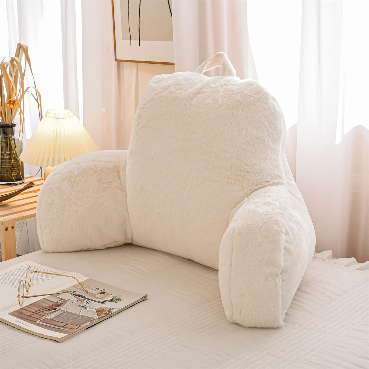 A Nice Night faux fur reading pillow on bed wedge ivory for cozy support.