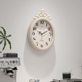 Abdurey compact oval clock showcases handcrafted texture for vintage-inspired interiors.