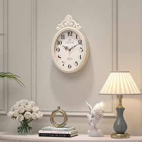 Abdurey oval wall clock for living room or hallway offers decorative charm and clear time.