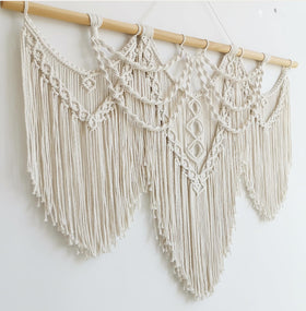 Achart macrame wall hanging wide boho pattern brings visual warmth.