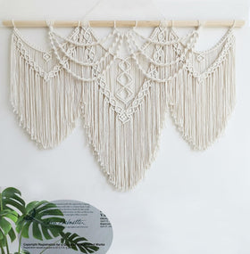 Achart macrame wall hanging in living room setting shows stylish decor.
