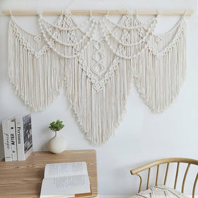 Achart macrame wall hanging wooden rod closeup shows natural cotton cords.