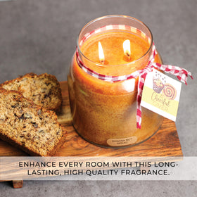 Brown glass candle with lid from A Cheerful Giver complements home decor.