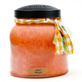 A Cheerful Giver Juicy Peach Papa candle jar emits fresh peach aroma for cozy spaces.