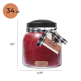 A Cheerful Giver Red candle in a glass jar enhances living room ambiance