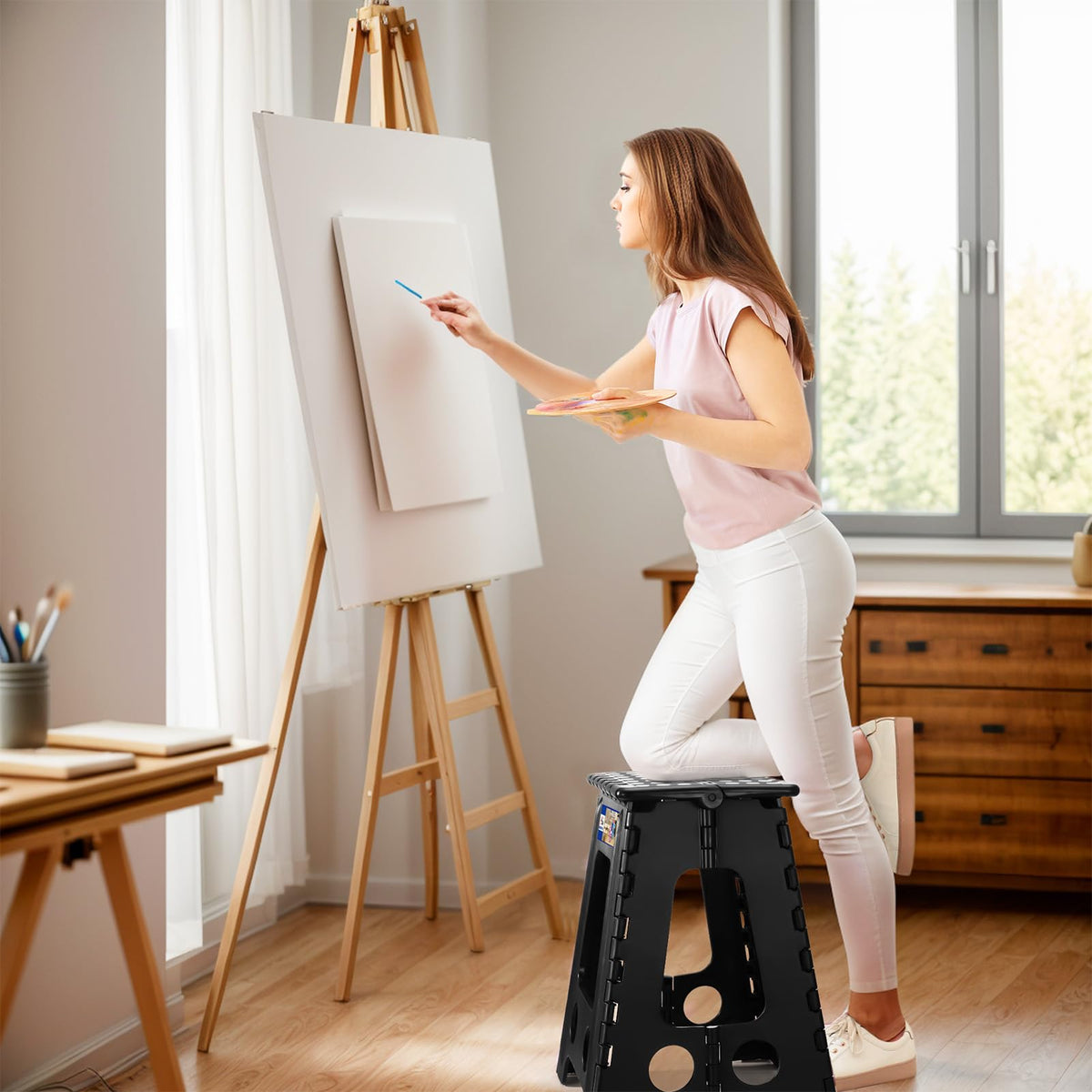 ACKO folding step stool open with handle for portability.