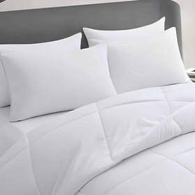 Acteb four-pack pillow set arranged for coordinated bedroom comfort.