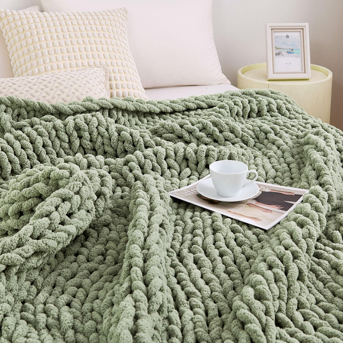 Admitrack chunky knit blanket in sage green draped over a sofa for cozy living room warmth.