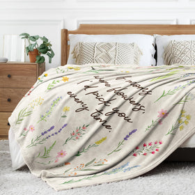 Afterprints floral mom blanket keeps mom cozy while reading in bed.