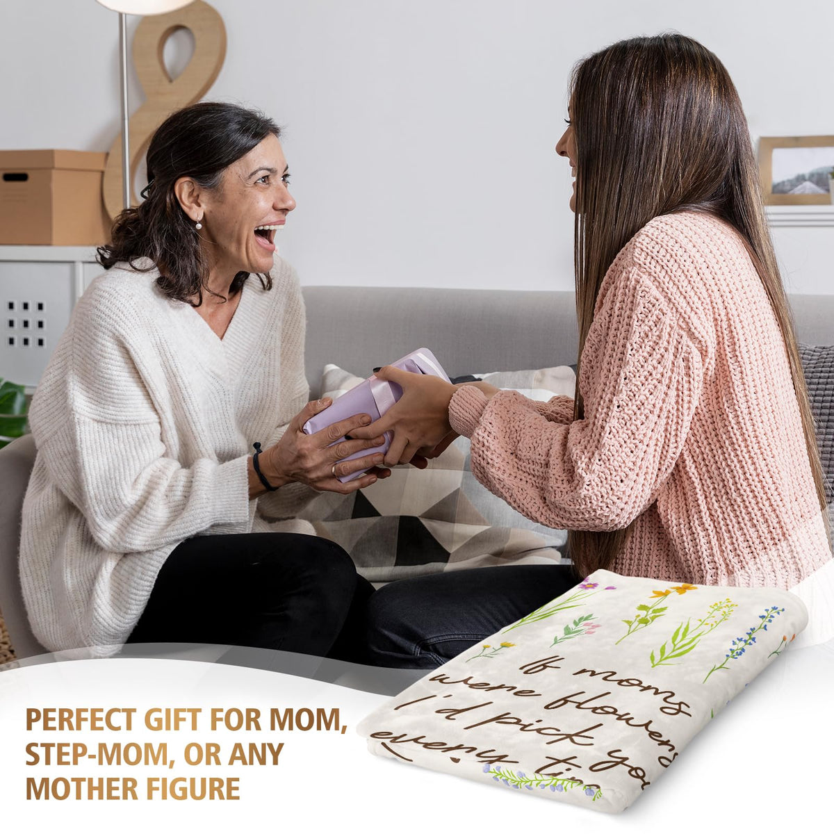 Afterprints floral mom blanket draped over a sofa for cozy evenings.