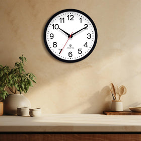 AKCISOT Atomic Black Wall Clock in office to help keep schedules on track