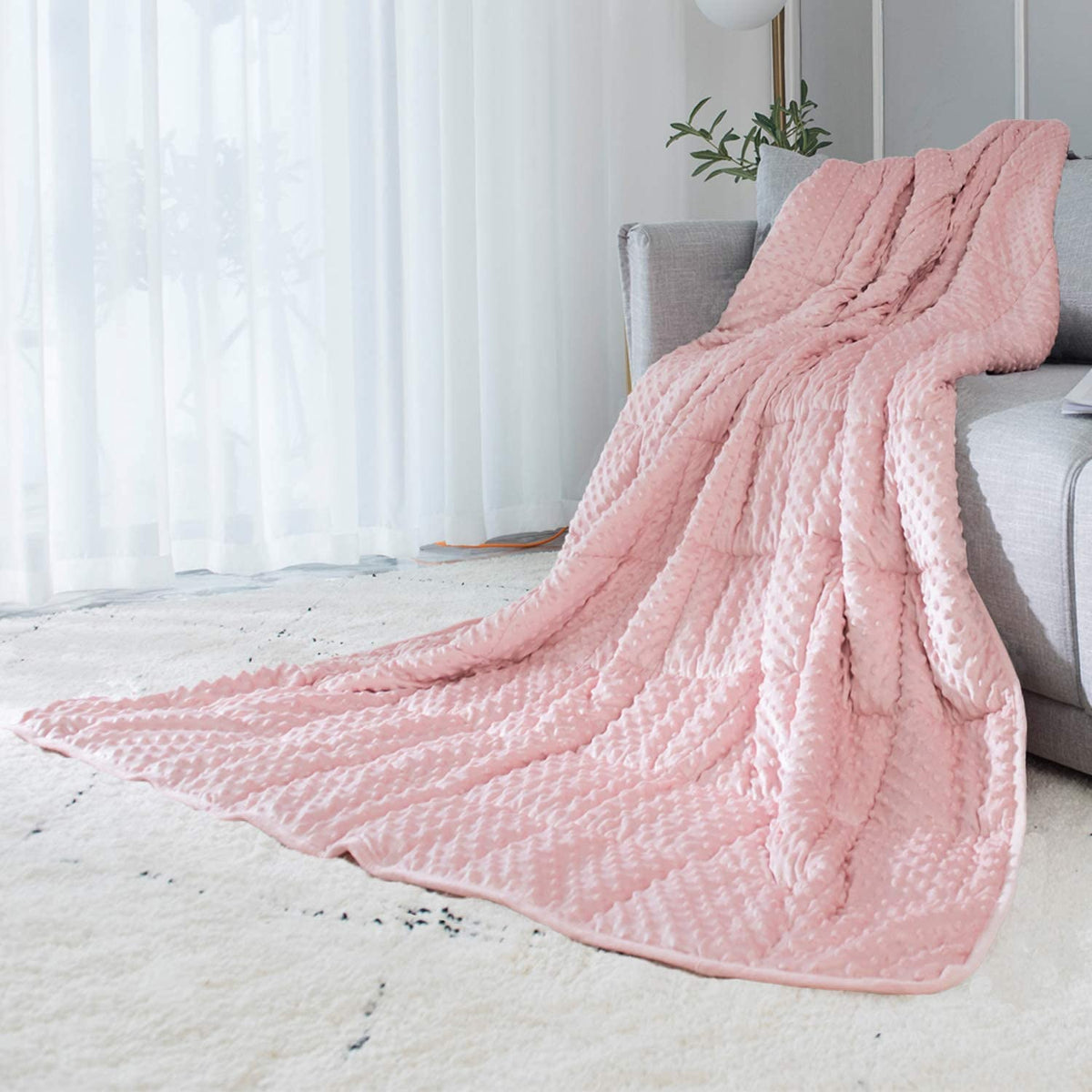 ALANSMA reversible velvet weighted blanket in pink provides gentle warmth.