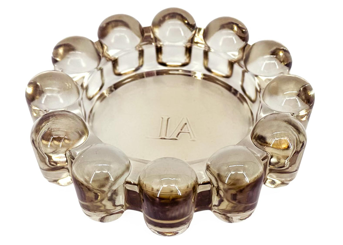 Alice Lane bubble dish in amber glass showcases elegant candle display.