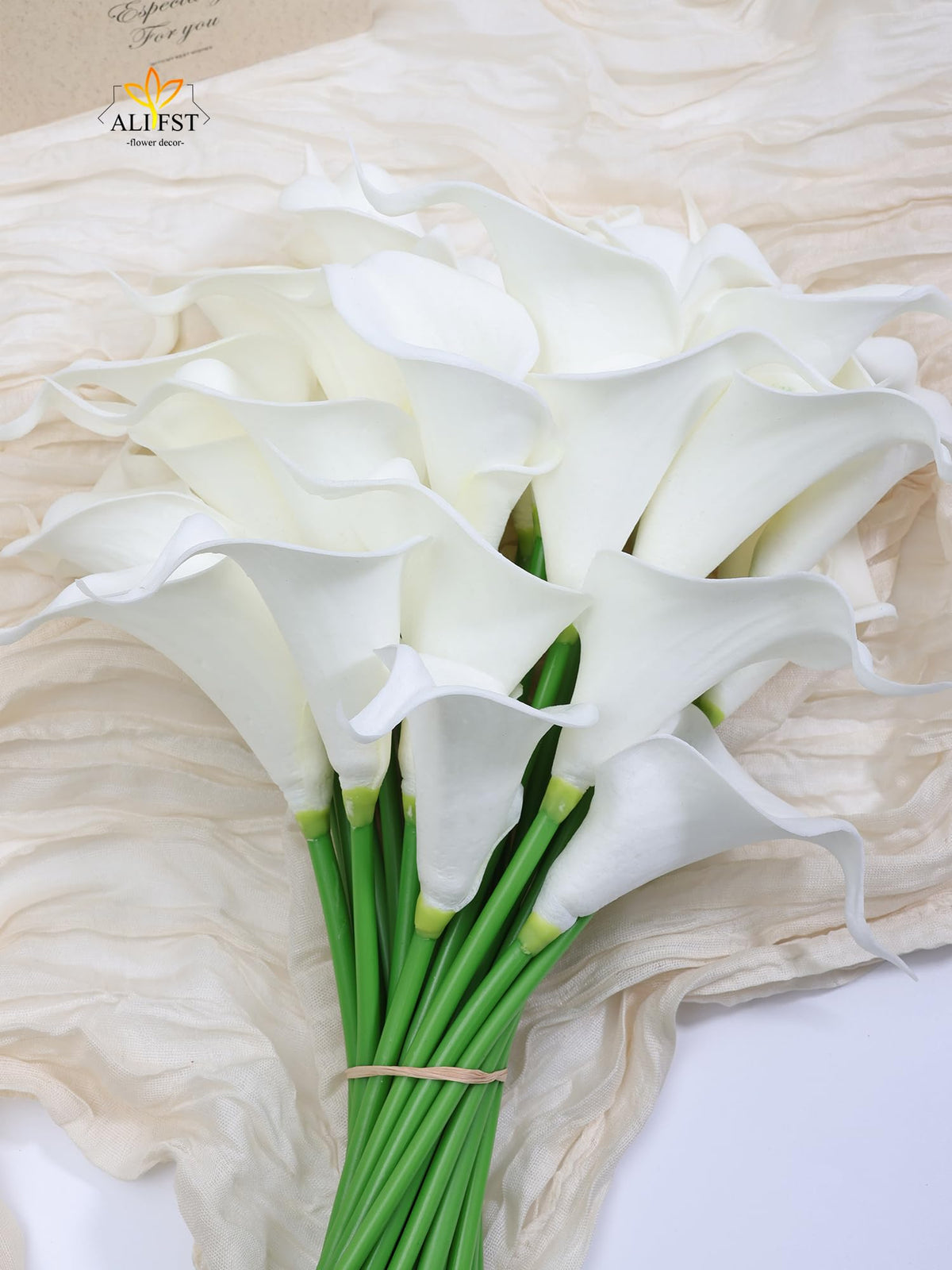 Alifst sleek white calla lilies enhance shower decor and photo backdrops.