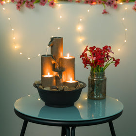 Alpine WCT202 tealight holders provide warm glow with gentle water sounds for cozy evenings.