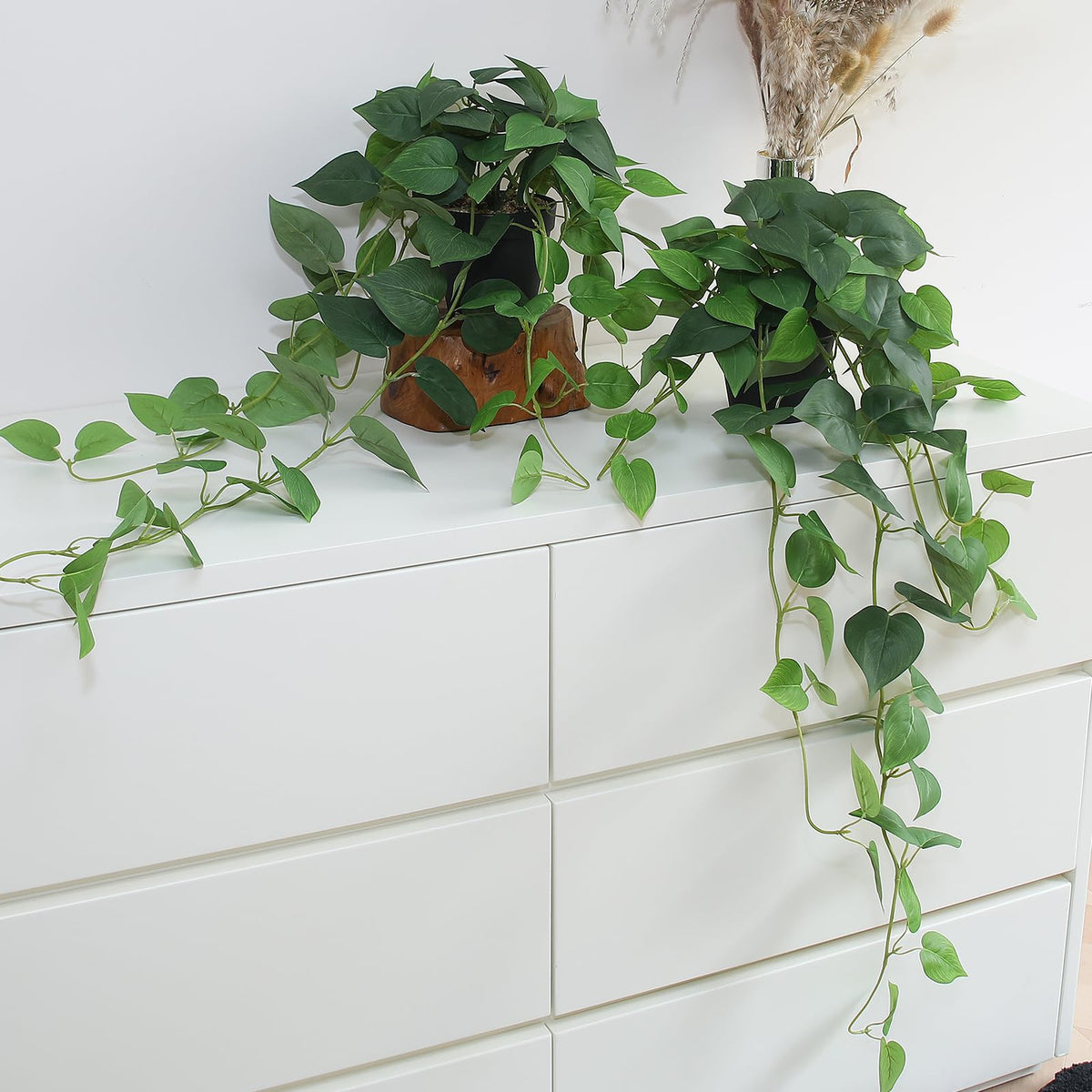 Alyptus fake pothos hanging plants in two pots add vibrant, low-maintenance greenery.