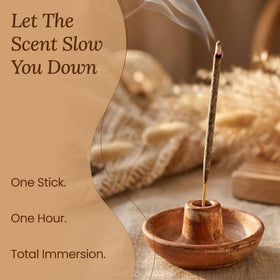 Amae incense stick burning softly, filling room with forest-like aroma.