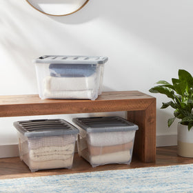 Amazon Basics gray-lid stackable storage bin provides space-saving organization.