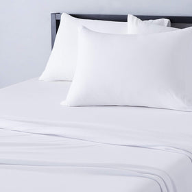 Amazon Basics twin flat sheet on bed with soft breathable cotton jersey feel