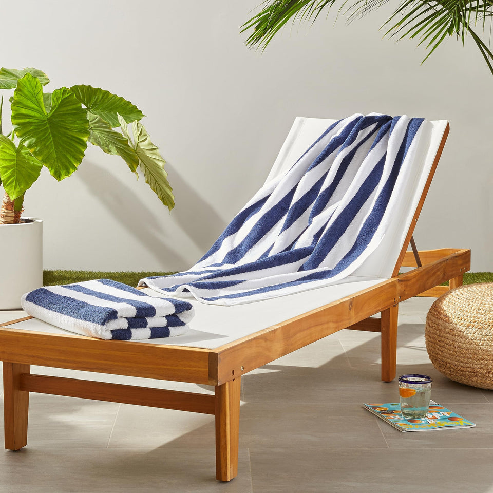 Amazon Basics Cabana Stripe Beach Towel folded navy blue, ready for travel and quick drying.