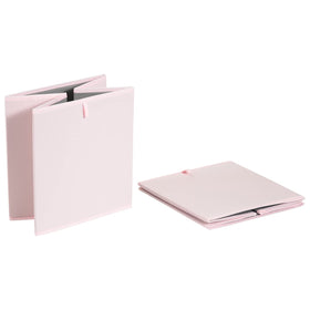 Amazon Basics peony pink cube organizer bin neatly placed in a closet for storage.