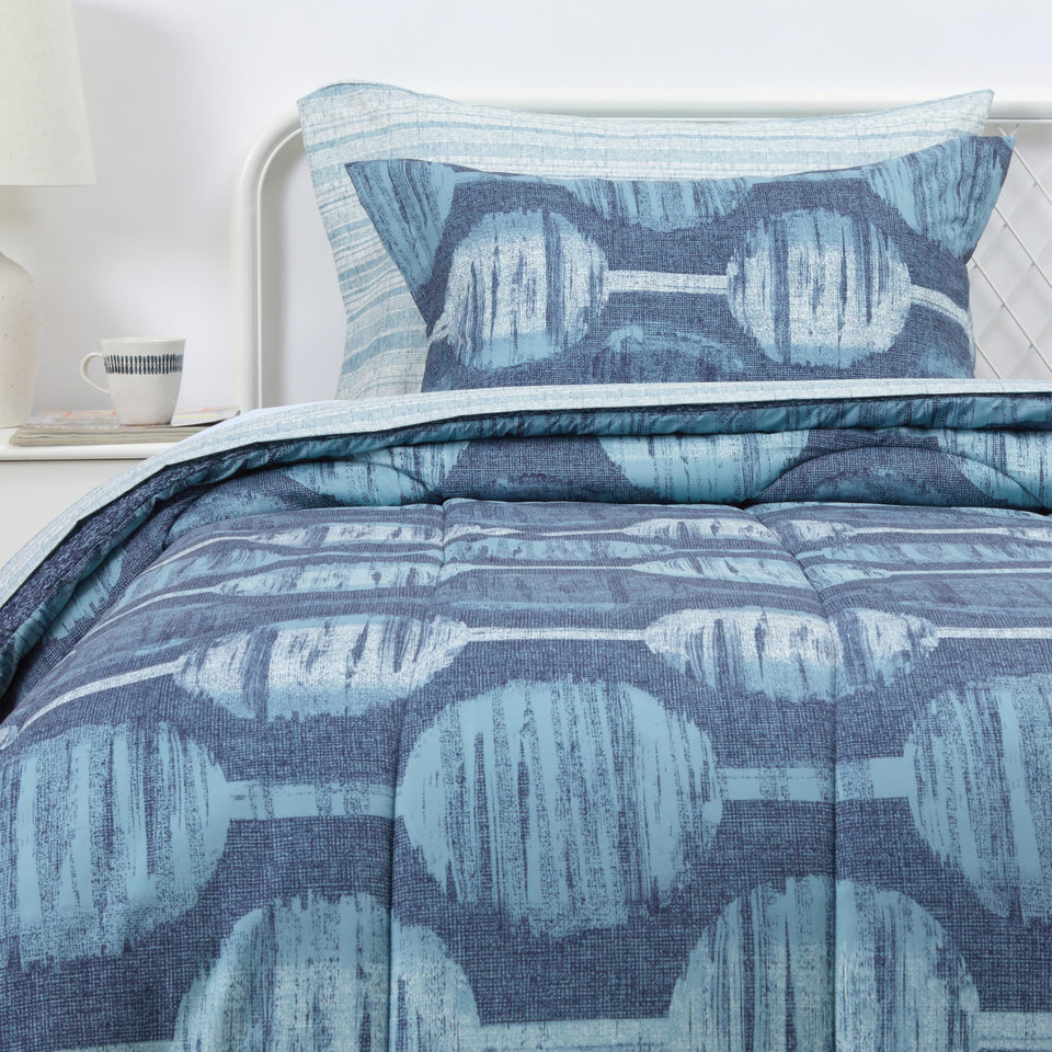 Amazon Basics comforter set in navy geometrics on twin-xl bed for cozy all-season sleep.