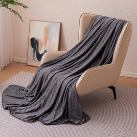 Amazon Basics cooling blanket on bed with reversible sides for temperature control.