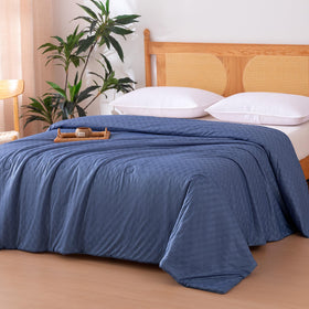 Amazon Basics cooling comforter close-up highlights breathable weave detail for hot sleepers.
