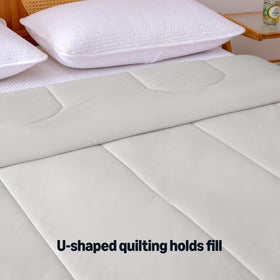 Amazon Basics cooling comforter on bed demonstrates breathable, lightweight layering.