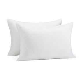 Amazon Basics down alternative pillow pair on bed, ideal for stomach and back sleepers.