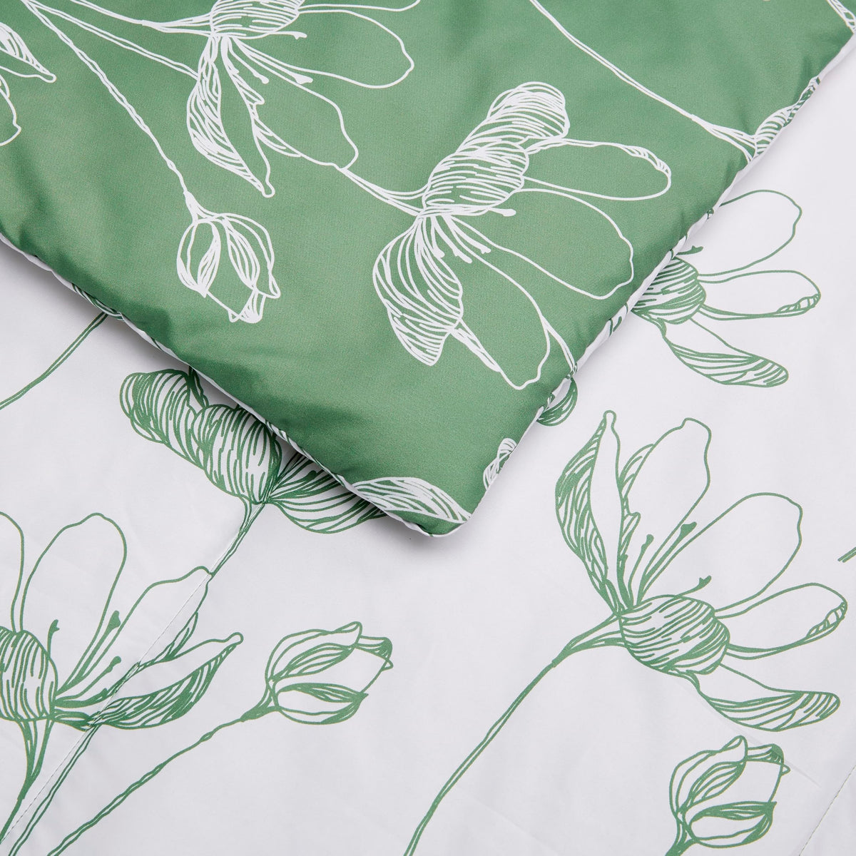 Amazon Basics green floral comforter displayed on a neatly made twin bed