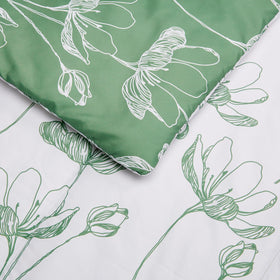 Amazon Basics green floral comforter displayed on a neatly made twin bed