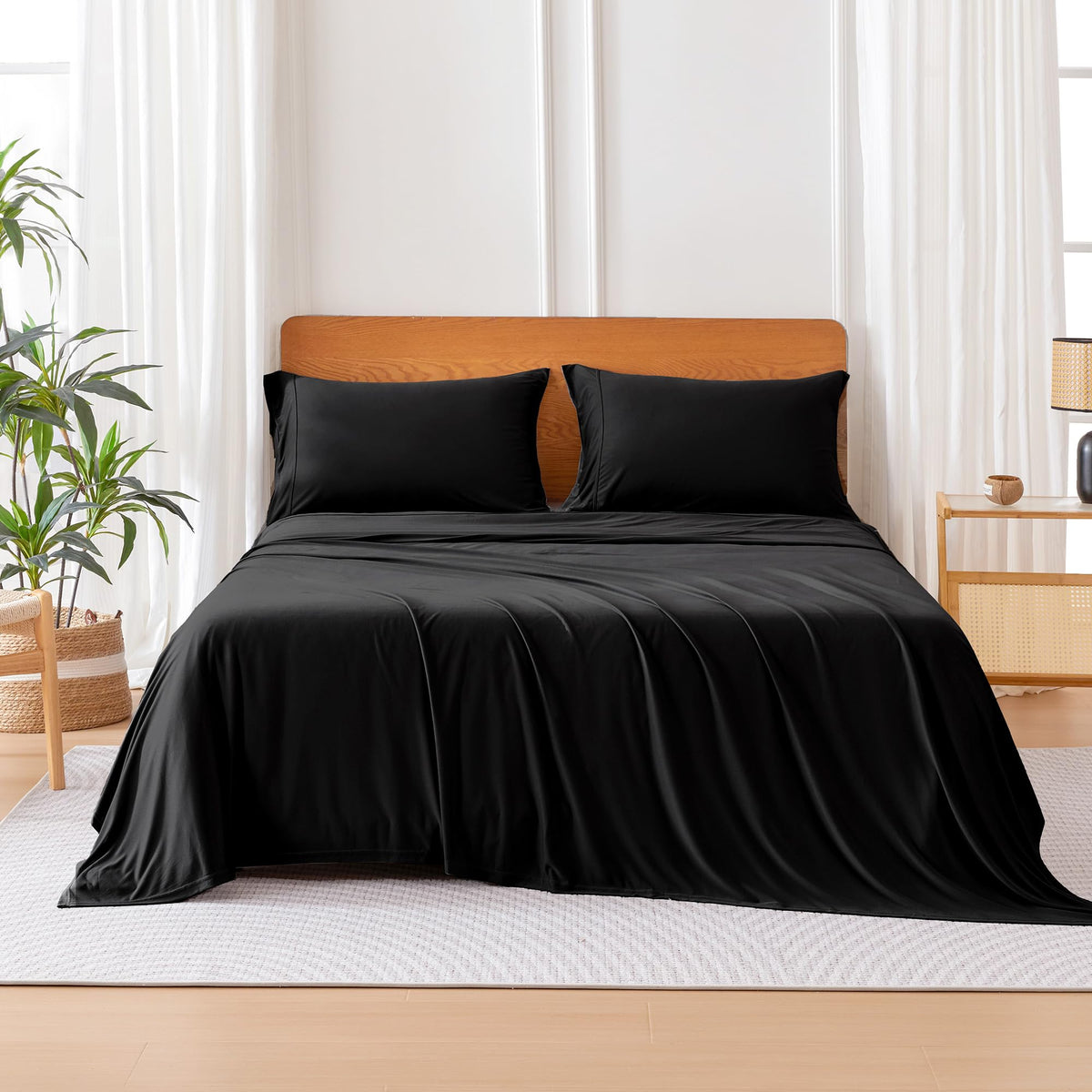 Amazon Basics jersey knit queen fitted sheet in black with 16-inch deep pockets for secure fit.
