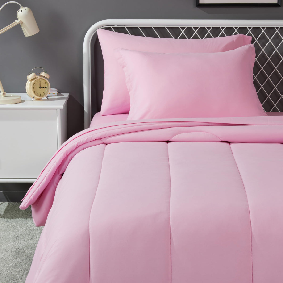 Amazon Basics pink kid bed-in-a-bag 5-piece set with plush comforter for cozy nights.