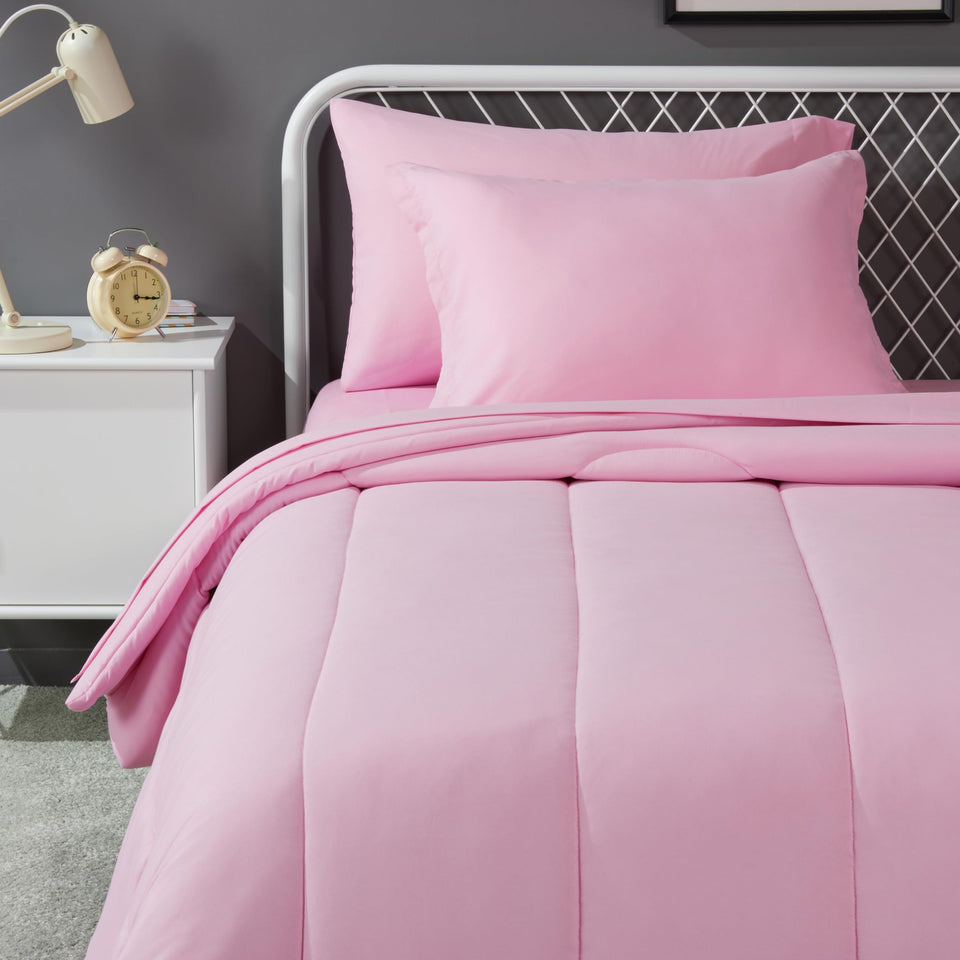 Amazon Basics pink kid bed-in-a-bag 5-piece set with plush comforter for cozy nights.