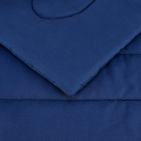 Amazon Basics navy kids bedding in a bright room; versatile color for mix-and-match.