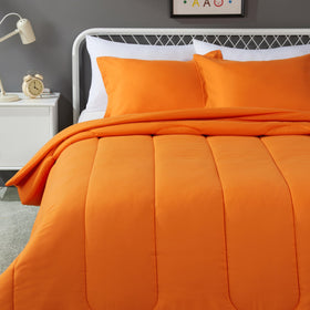 Amazon Basics kids comforter in bright orange adds playful, cozy style.