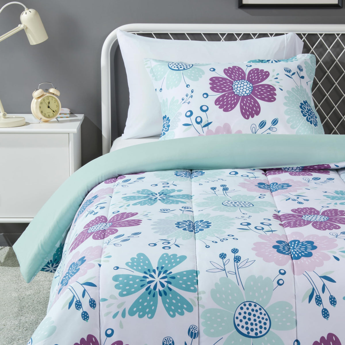 Amazon Basics kids comforter set on bed with purple flowers for playful sleep space