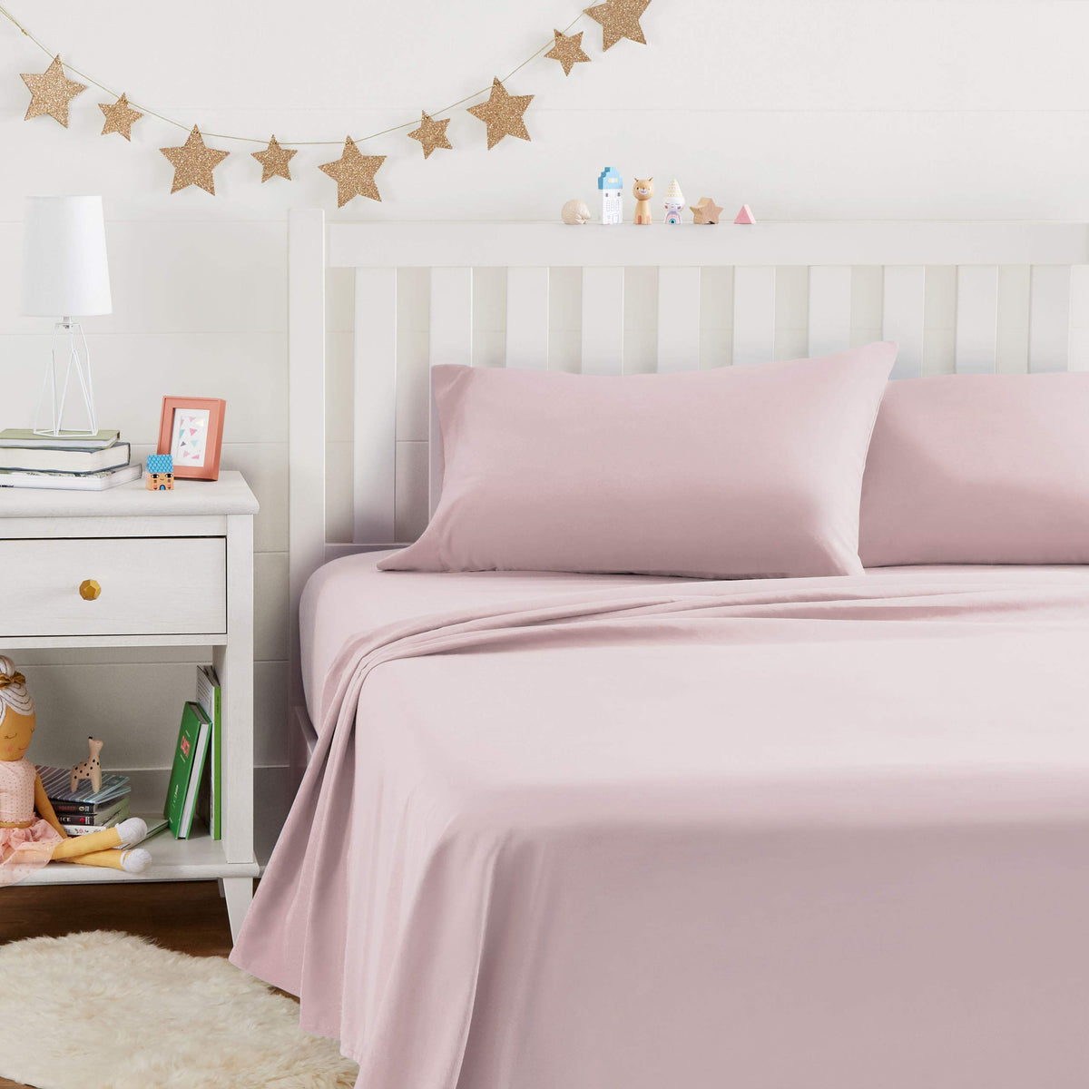 Amazon Basics kid's sheet set light pink flat sheet for year-round softness.