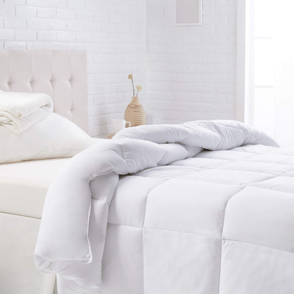 Amazon Basics king comforter close-up shows plush warmth and soft polyester fabric.