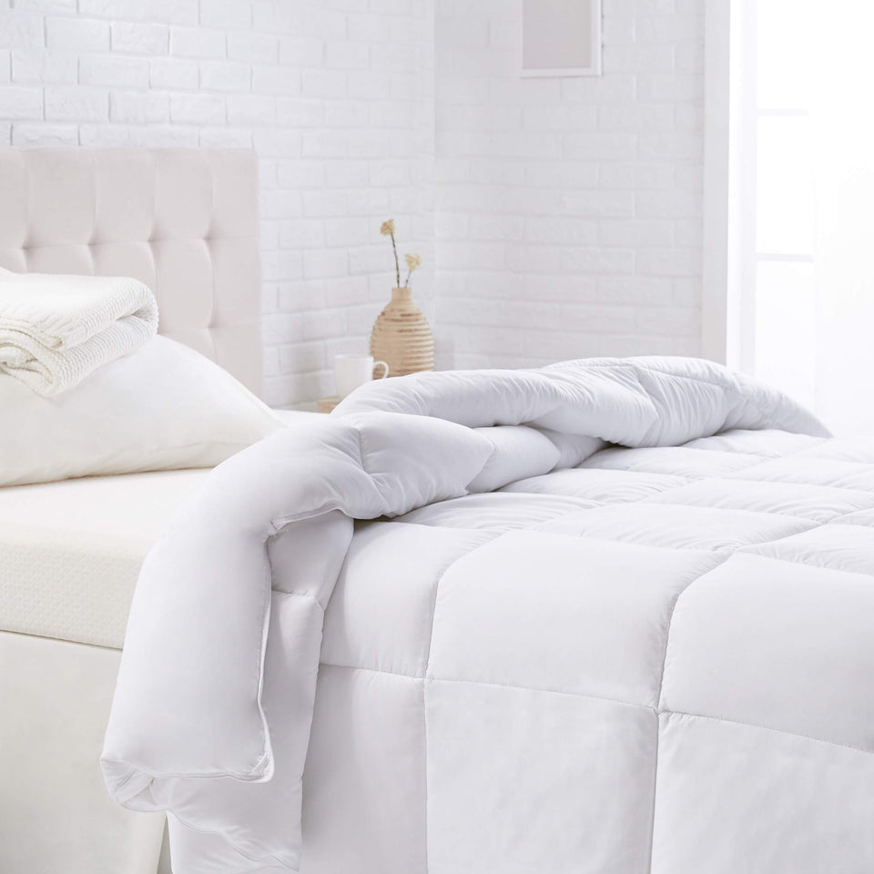 Amazon Basics king comforter close-up shows plush warmth and soft polyester fabric.