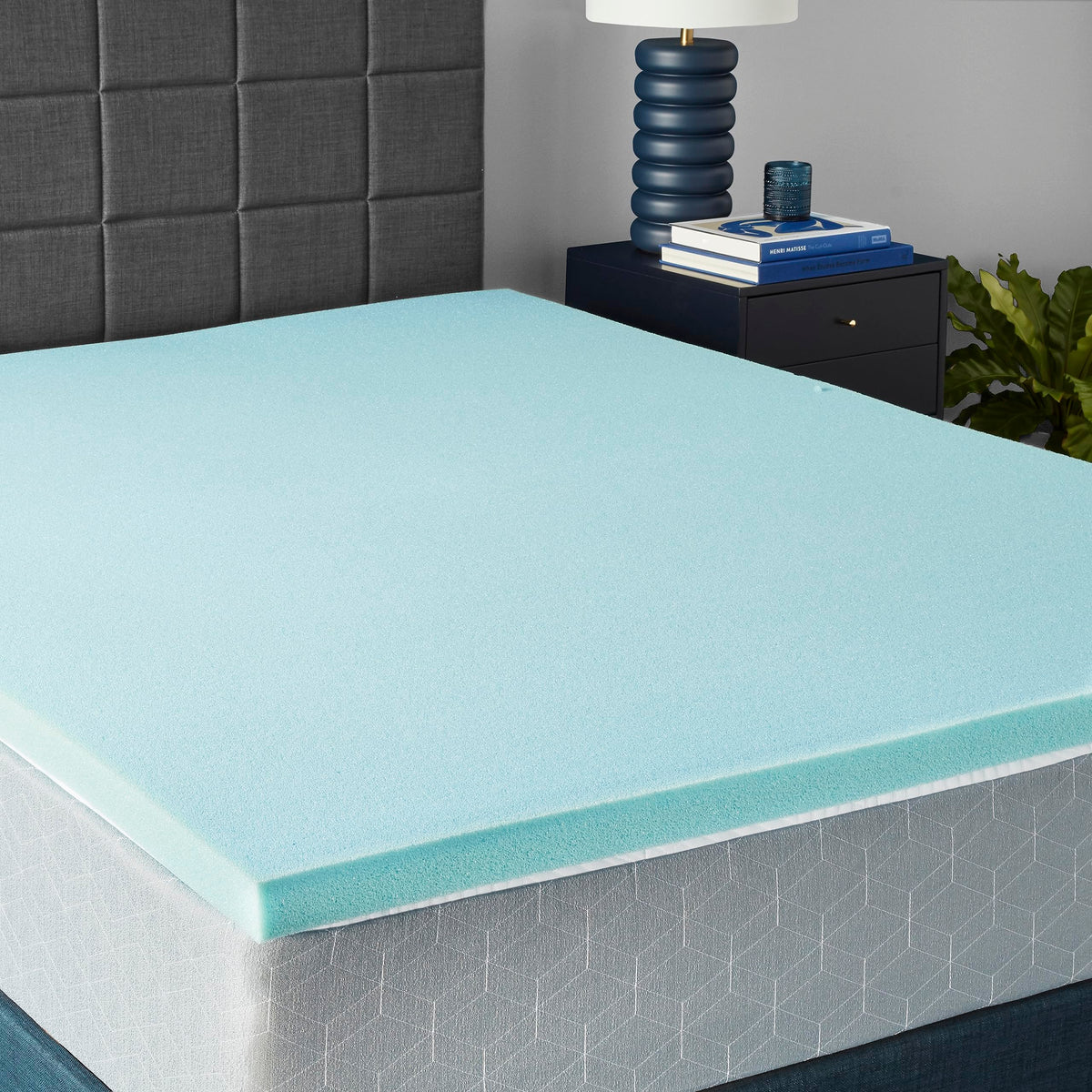 Amazon Basics queen cooling topper unrolled on bed for added comfort and support
