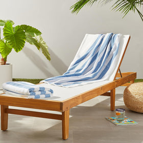 Amazon Basics soft and absorbent beach towel in cabana stripe, sky blue, ideal for beach drying.