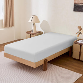 Amazon Basics king fitted sheet on bed, highlighting secure 14-inch deep pocket.